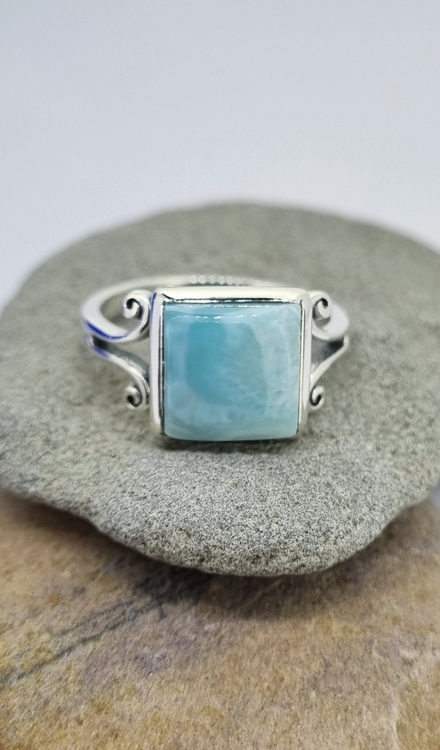 What a little beauty! Exquisite silky Larimar ring adorned by swirling sterling silver.