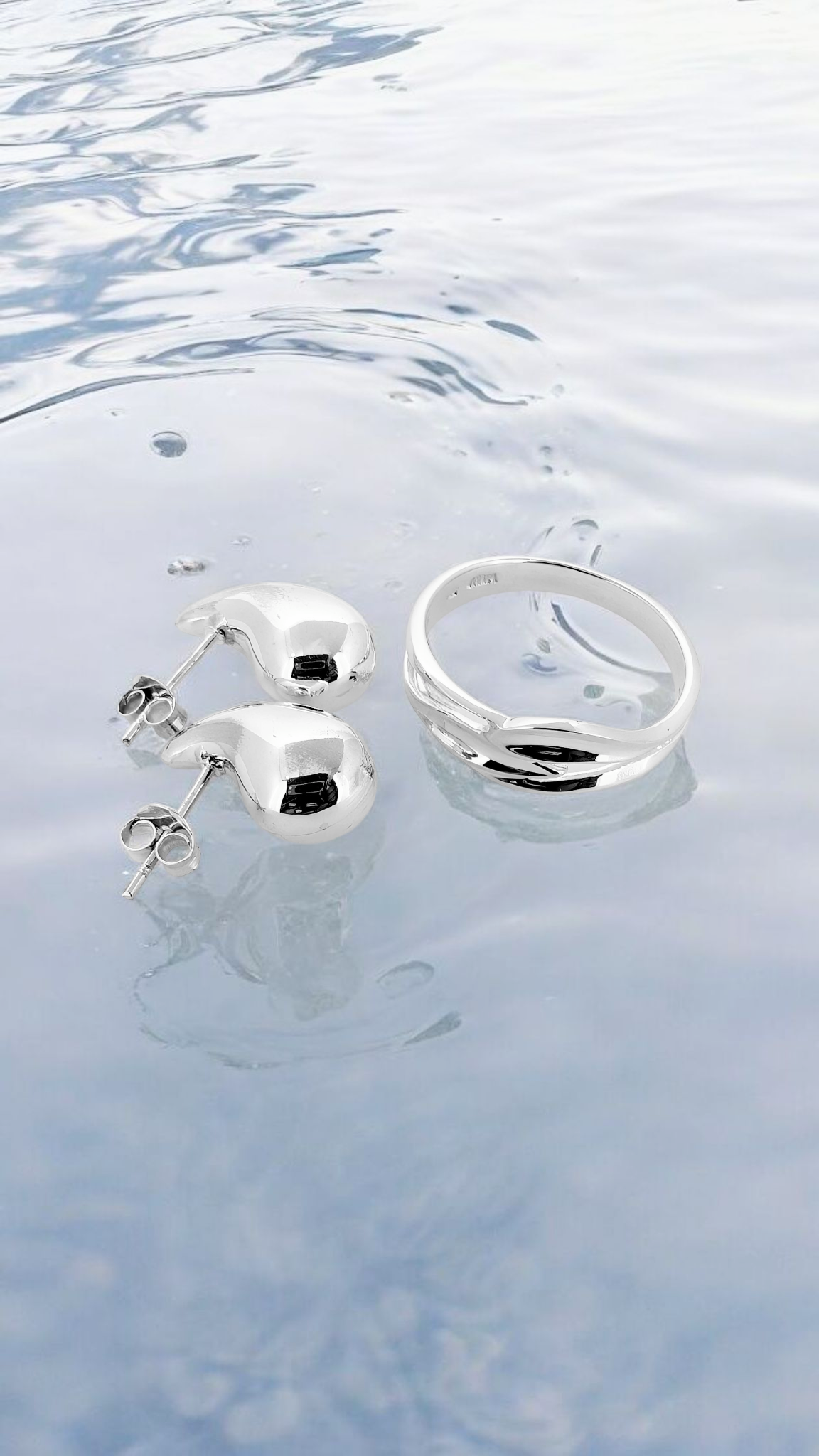 Silver combo - sterling silver ring gracefully entwined in a fluid wave-like design, paired with teardrop studs